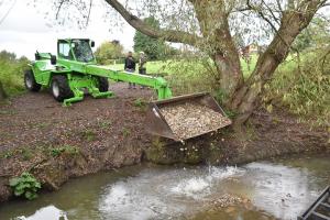 Placing gravel in the brook
